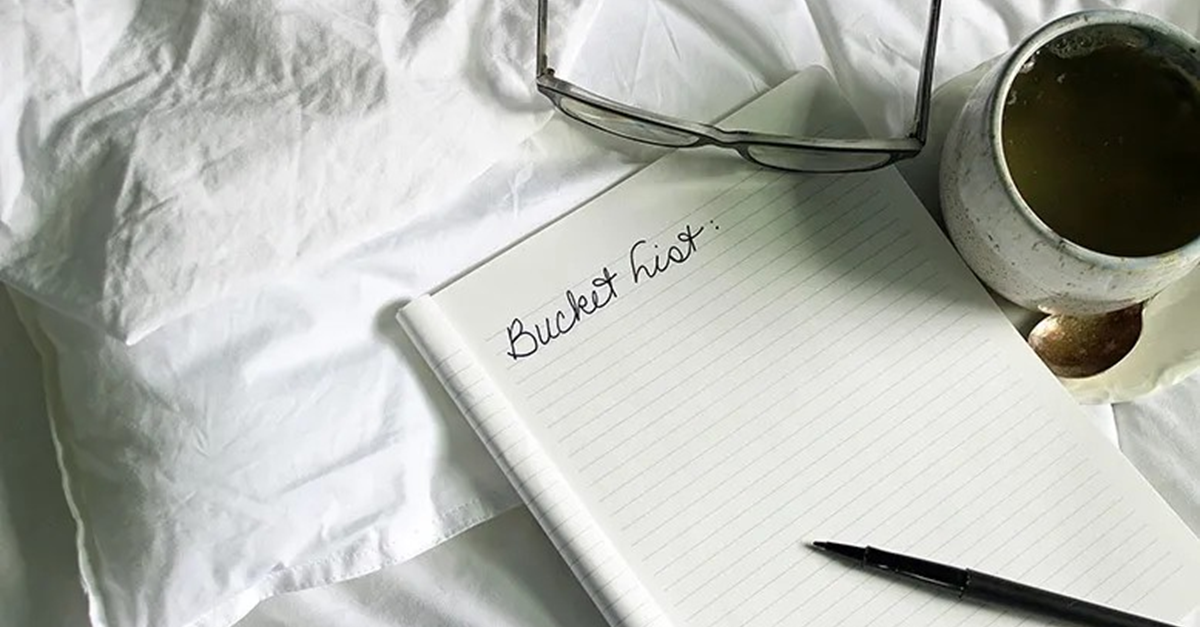 notebook with bucket list and cup of coffee
