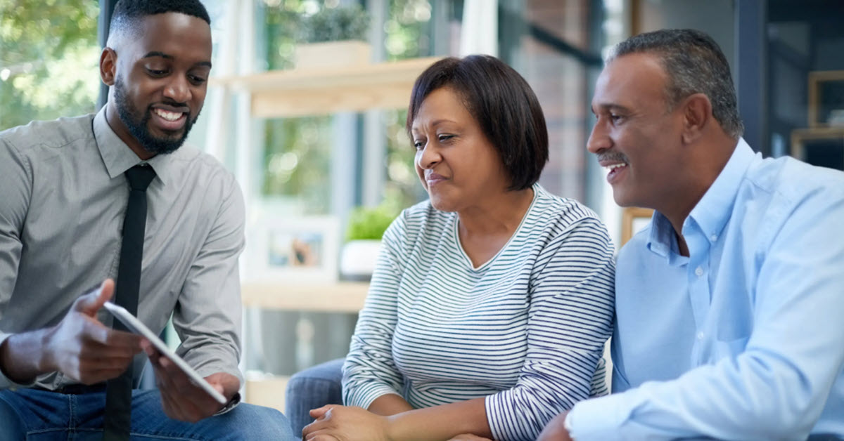 Couple meeting with advisor at home