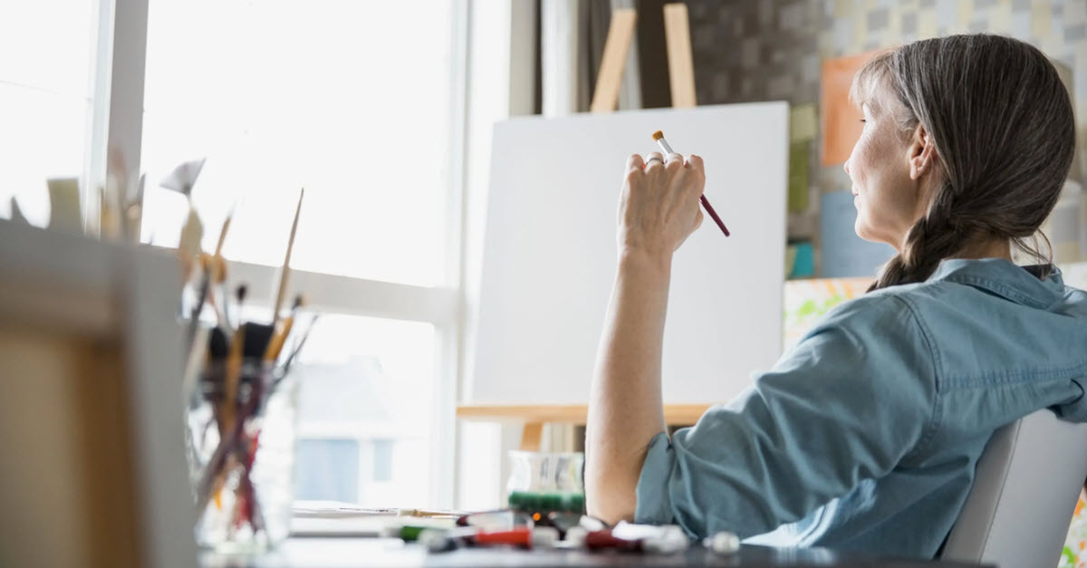 woman holding paintbrush in page