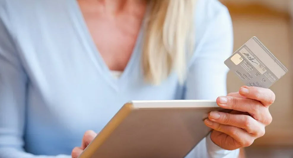 woman with iPad and credit card