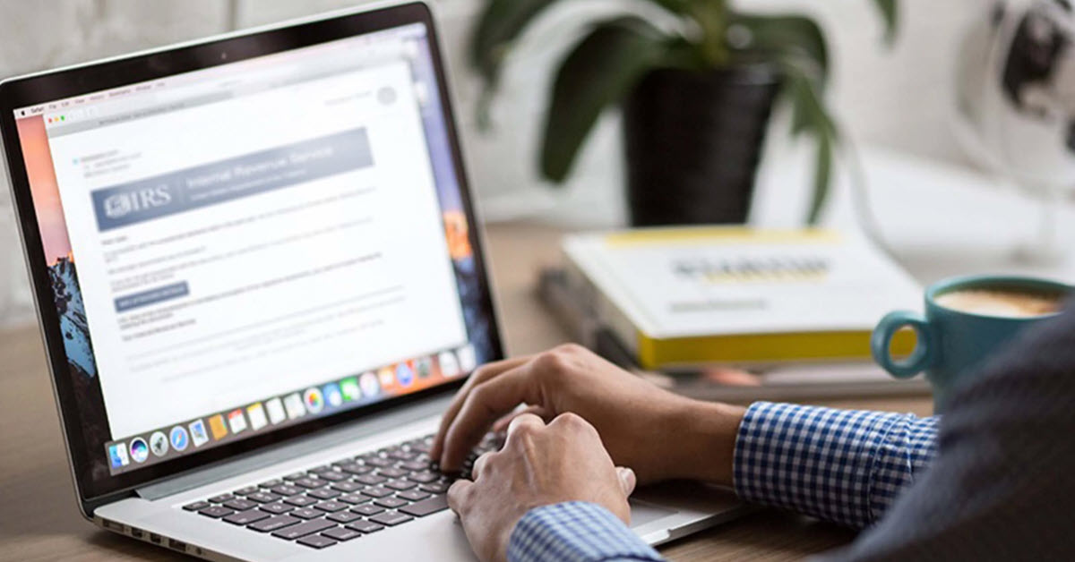 Man filing taxes on laptop