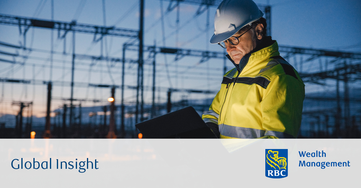 Worker looking at laptop at a powerplant