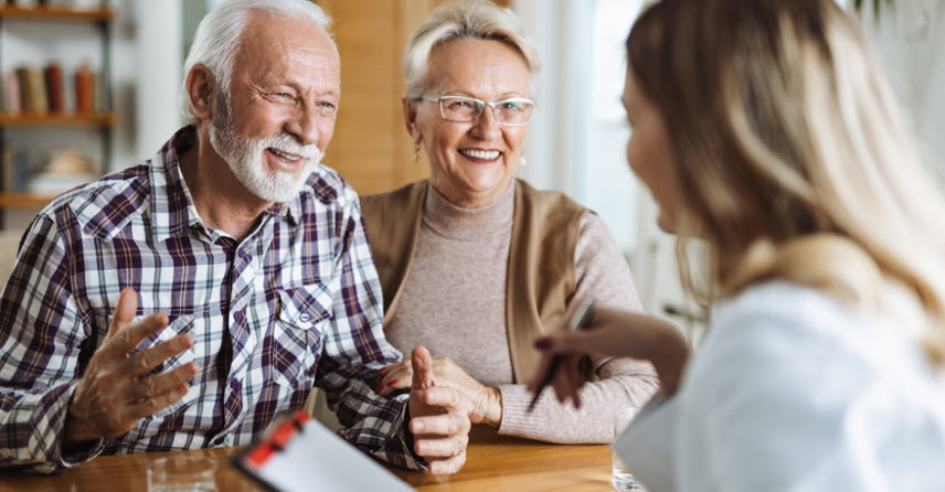 Older parents talking with their daughter about finances