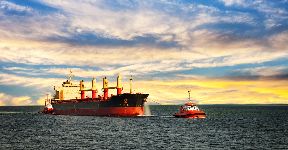 Tug boat pulling a large container boat